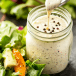 Homemade peppercorn ranch dressing drizzled over fresh salad